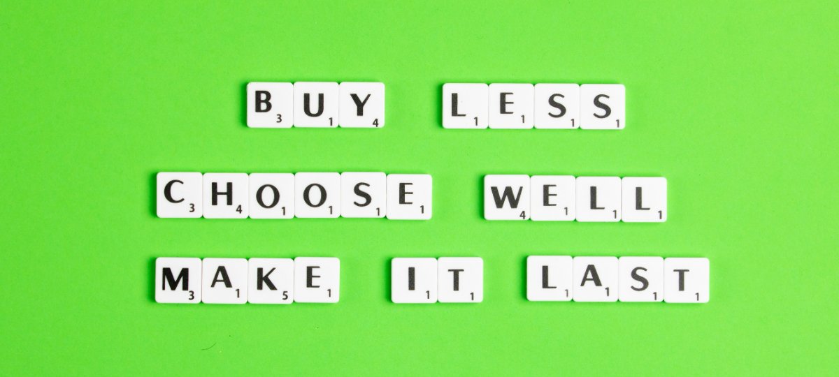 Scrabble tiles on a bright green background spelling BUY LESS, CHOOSE WELL, MAKE IT LAST