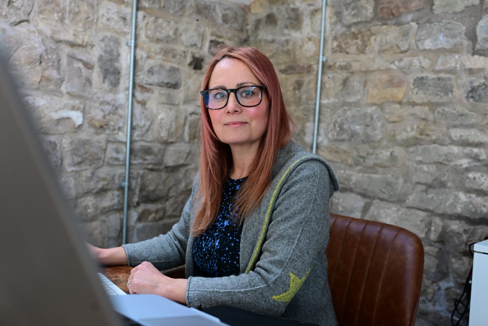 Estelle Pearce, founder of Closet Remix, working on the app at her desk